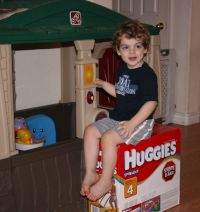 Mark sitting on box by playhouse