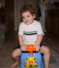 Mark playing on Pooh car