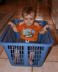 Andrew in blue laundry basket