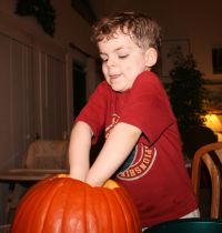 Mark using both hands to get stuff out of the pumpkin