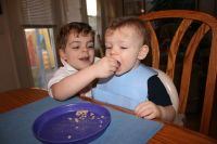 Mark feeding cereal to Andrew