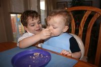 Mark feeding cereal to Andrew