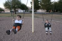 Mark and Andrew on swings at park